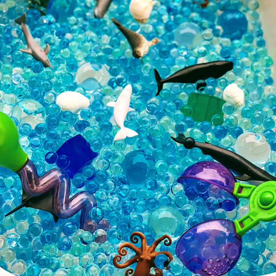 Sensory play ocean colour water beads with mini toy ocean animals and sensory play tools for exploring